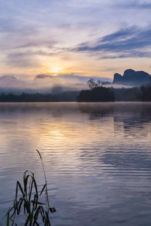 Ban Nong Thale the natural scenery of the sunshine in the morning (mountains, lakes, trees, fog) at Krabi, Thailand.の写真素材