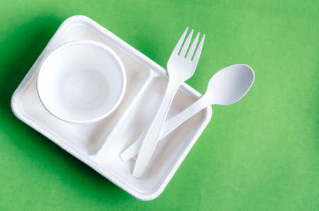 Eco friendly biodegradable paper disposable for packaging food and paper glass on green background.の写真素材