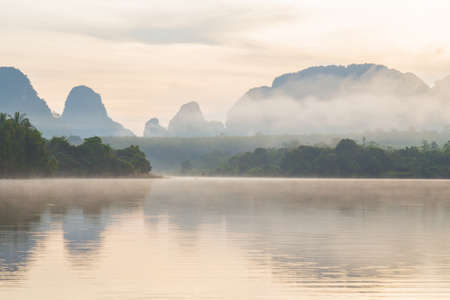 Ban Nong Thale the natural scenery of the sunshine in the morning (mountains, lakes, trees, fog) at Krabi, Thailand.の写真素材