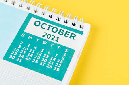 Close up October 2021 desk calendar on yellow table.の写真素材