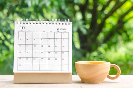 October 2021 Calendar desk for organizer to plan and reminder on wooden table on nature background.の写真素材