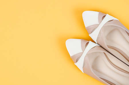 Modern women shoes on yellow background.の写真素材