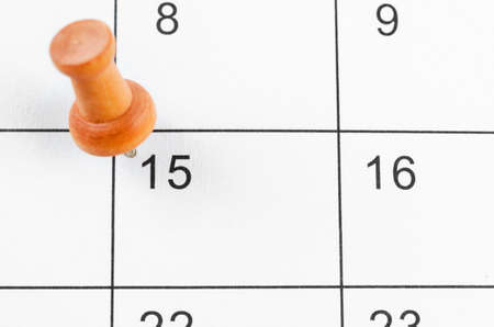 Embroidered  wooden pin on a blank calendar on the 15th for your text or message.の写真素材