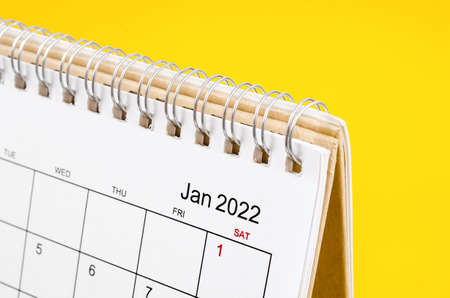 Close-up January 2022 desk calendar on yellow background.の写真素材