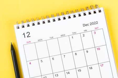 Close-up December 2022 desk calendar on yellow background.の写真素材