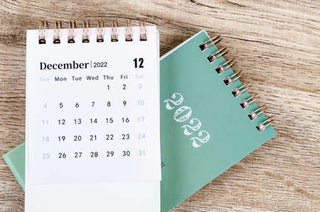 The December 2022 desk calendar on wooden table.の写真素材