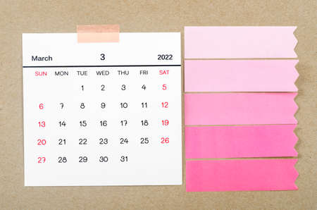 March 2022 calendar with blank adhesive note paper on brown background.の写真素材