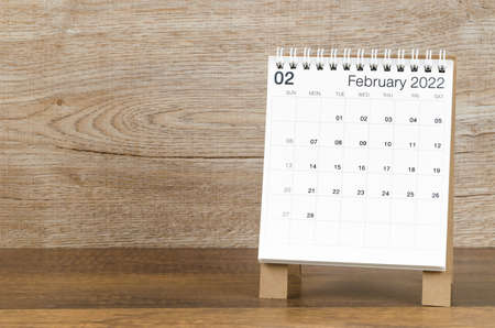 The February 2022 desk calendar on wooden background.の写真素材