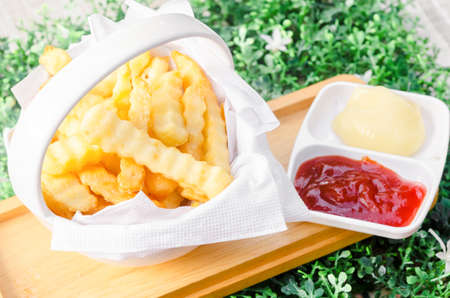 The Fresh fried french fries with ketchup and white sauce