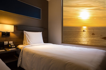 The Minimalist Bedroom Interior With Sea View in sunset time.の写真素材