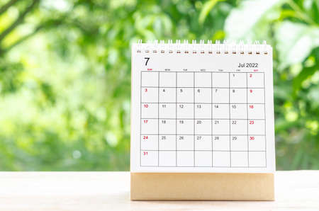 The July 2022 Calendar desk for organizer to plan and reminder on wooden table on nature background.の写真素材