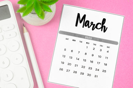 March 2023 Monthly calendar for 2023 year with calculator on pink background.の写真素材