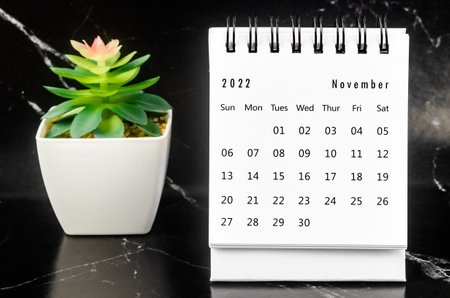 November 2022 Monthly desk calendar for 2022 year on black marble background.