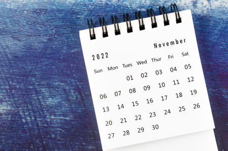 November 2022 Monthly desk calendar for 2022 year on old blue wooden background.の写真素材