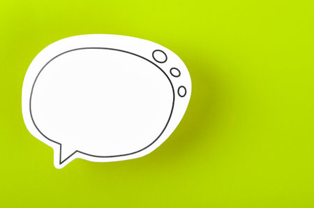 Speech bubble with copy space communication talking speaking concepts on green background.