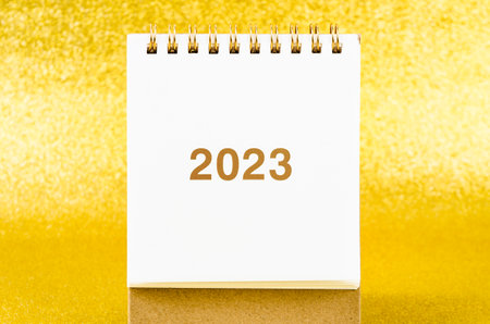 2023 Desk calender on golden color background.