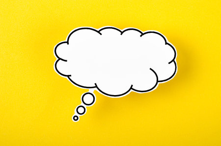 Speech bubble with copy space communication talking speaking concepts on yellow background.の写真素材