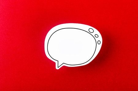 Speech bubble with copy space communication talking speaking concepts on red background.の写真素材