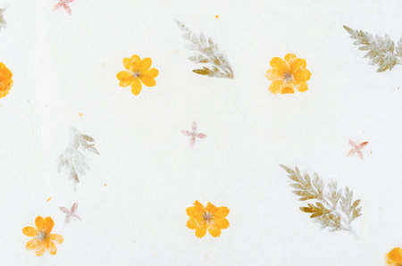 Handmade recycled flower and leaf paper or Mulberry paper texture as background.