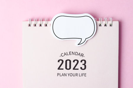 2023 desk calendar with speech bubble on pink backgroundの写真素材