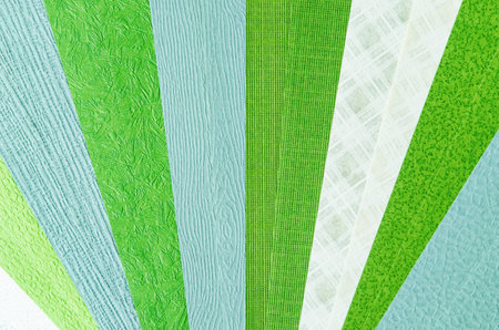 A color swatch of green paper texture made from recycled paper is used by designers to define the right colors for a project.の写真素材