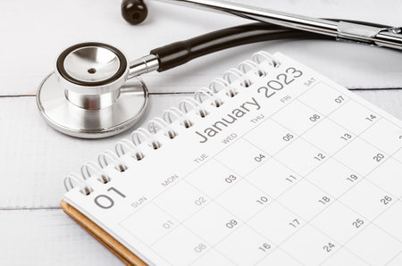 Stethoscope medical and calendar wooden background, schedule to check up healthy concepts.の写真素材