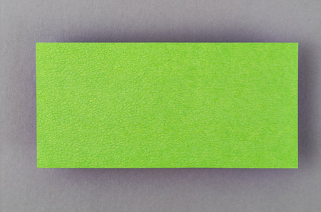 Blank green note paper on grey colour background.の写真素材