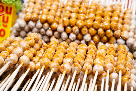 Grilled meatballs with sauce Grilled meatballs are a popular snack at street food or night markets. Food and small business concept.の写真素材