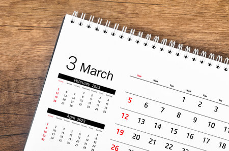March 2023 Monthly desk calendar for 2023 year on wooden floor.