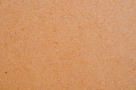 Brown chipboard surface texture as background.