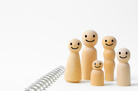 Happy face on wooden figures of family members. Emotion and satisfaction family concepts.の写真素材