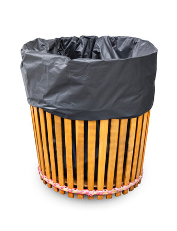 Wooden trash can with black bag isolated on white background, Save clipping path.の写真素材