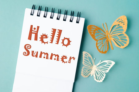 Hello summer on note book and paper butterfly carve.の写真素材