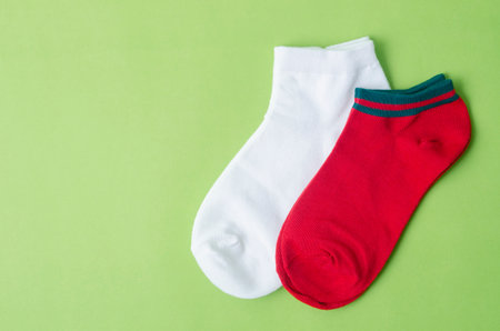 Red and white color Socks on green background.の写真素材