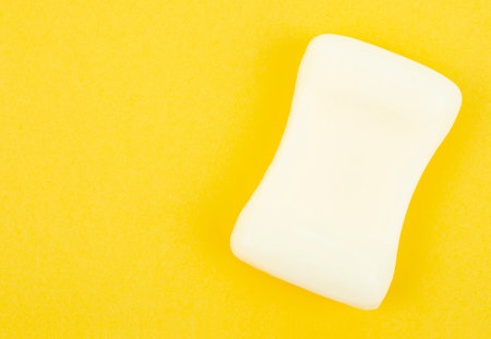 Natural white herb soap bars on yellow background with copy space.の写真素材