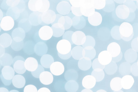 Light blue glitter festive abstract background with bokeh lights.の写真素材