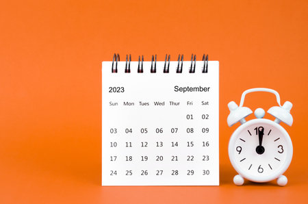 September 2023 Monthly desk calendar for 2023 year and alarm clockの写真素材