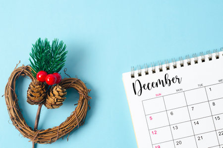 December desk calendar and christmas decorate on blue background.