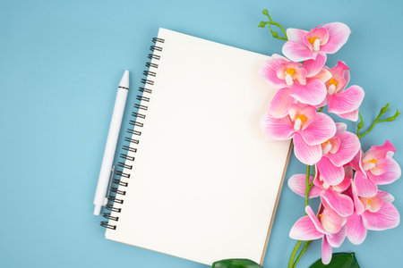 Blank open notebook and pink color orchid for your text or message.の写真素材