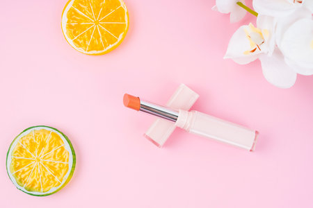 Red color beautiful lipsticks on pink with decoration background.の写真素材