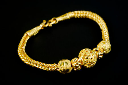Gold bracelet on black background.の写真素材