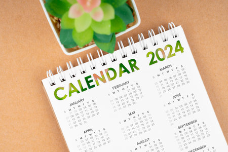 12 months desk calendar 2024 on brown background.の写真素材