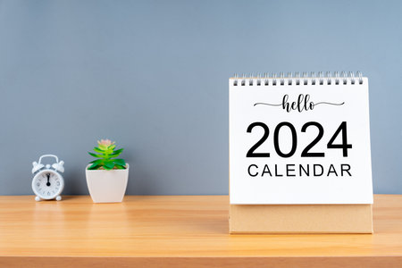 Hello 2024 calendar on wooden table and gray background. New Year plans for 2024 concepts.の写真素材