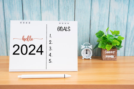 Hello 2024  with GOALS word on wooden table. time for a New Start, Resolution, Plan, Action and...