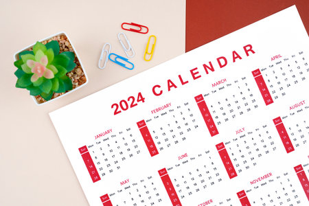Calendar 2024 page with paper clip and plant pot on beautiful background.の写真素材