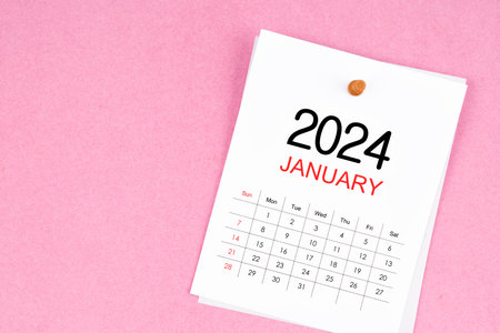 January 2024 calendar page and wooden push pin on pink Color background.の写真素材