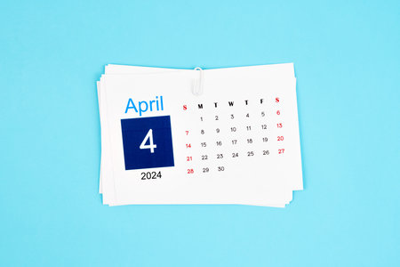 April Calendar 2024 page on blue background.の写真素材