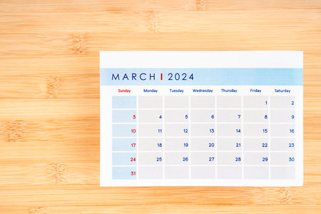 March 2024 calendar page on wooden background with empty space.の写真素材