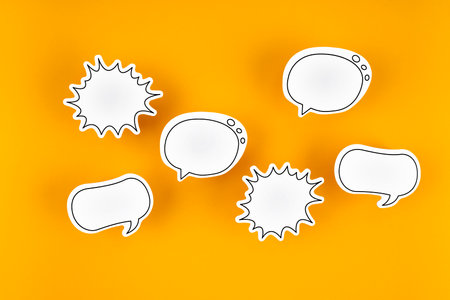 Empty white chat bubbles over yellow background. Great use for online messaging concepts.の写真素材