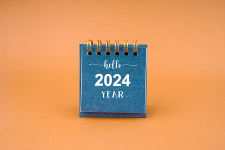 Hello 2024 calendar. Desk calendar 2024 on brown background.